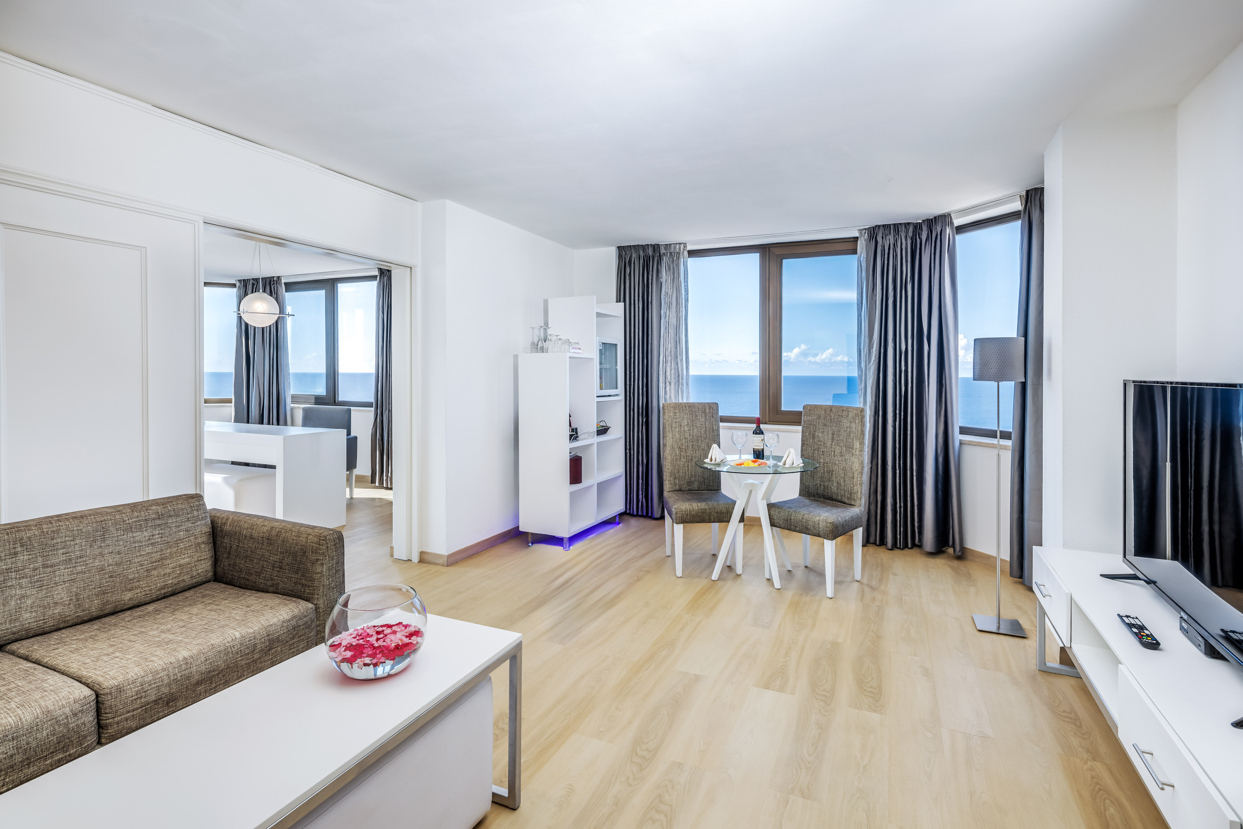 a living room with a table and chairs
