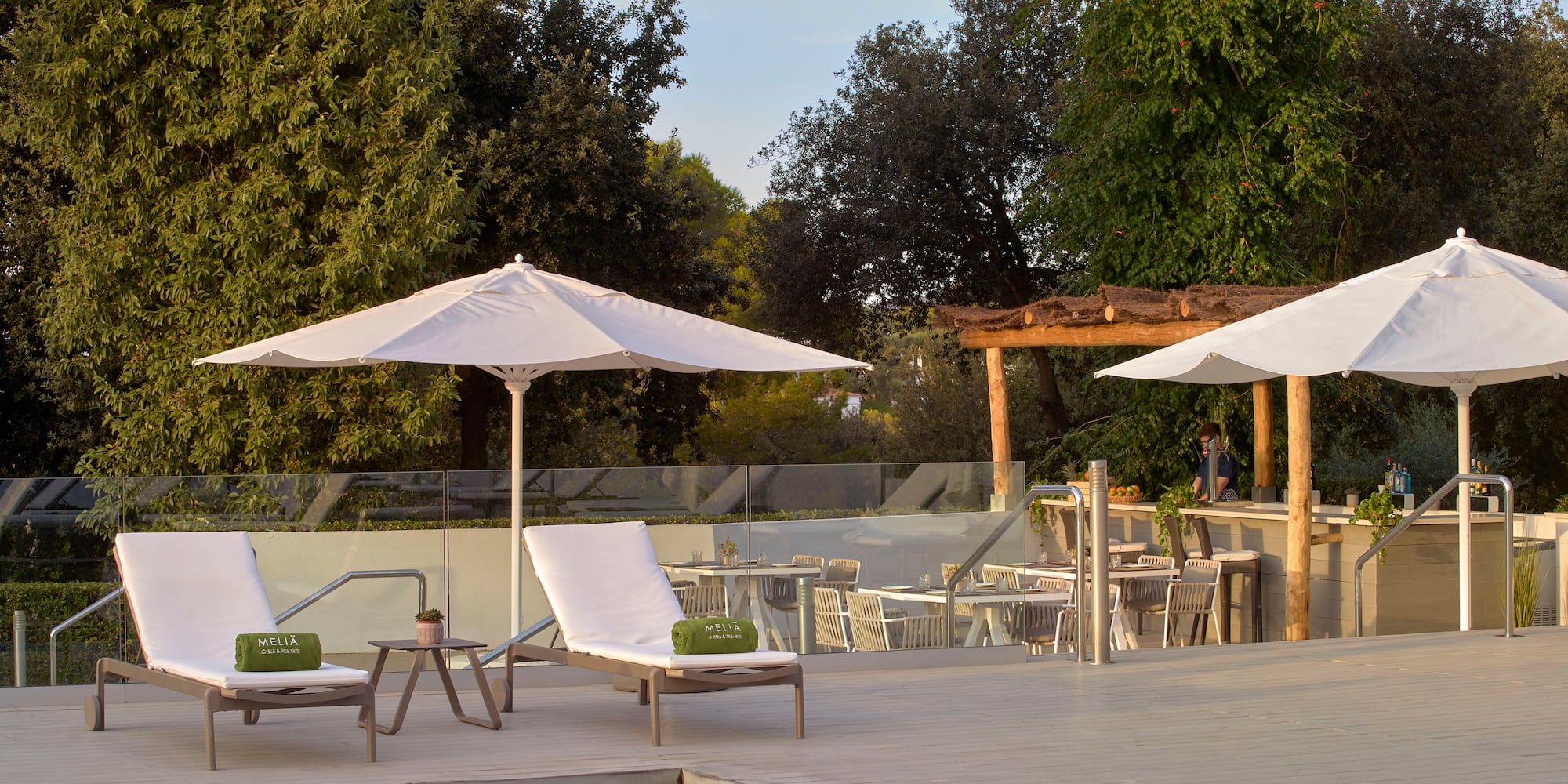 a pool with chairs and umbrellas