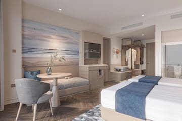 a room with two beds and a table