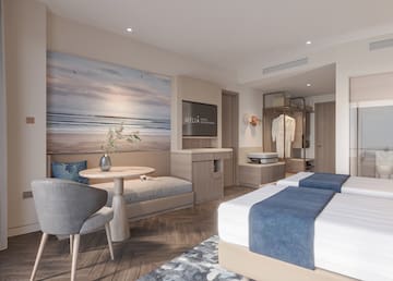 a room with two beds and a table