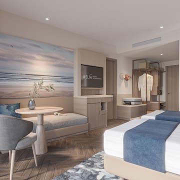 a room with two beds and a table