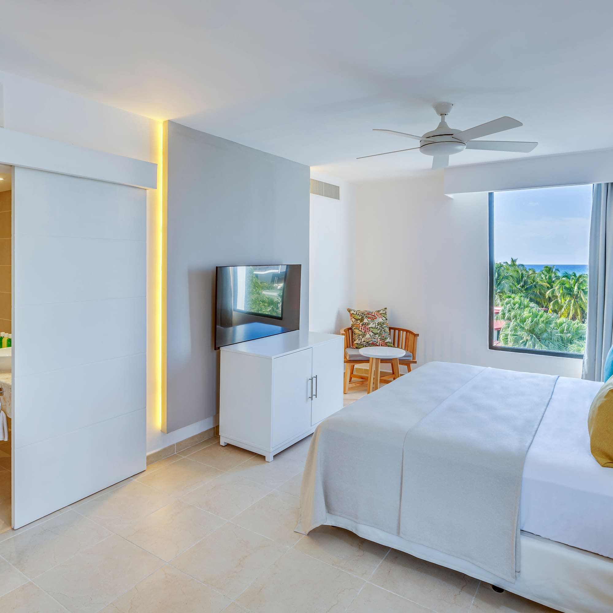 a bedroom with a bed and a television