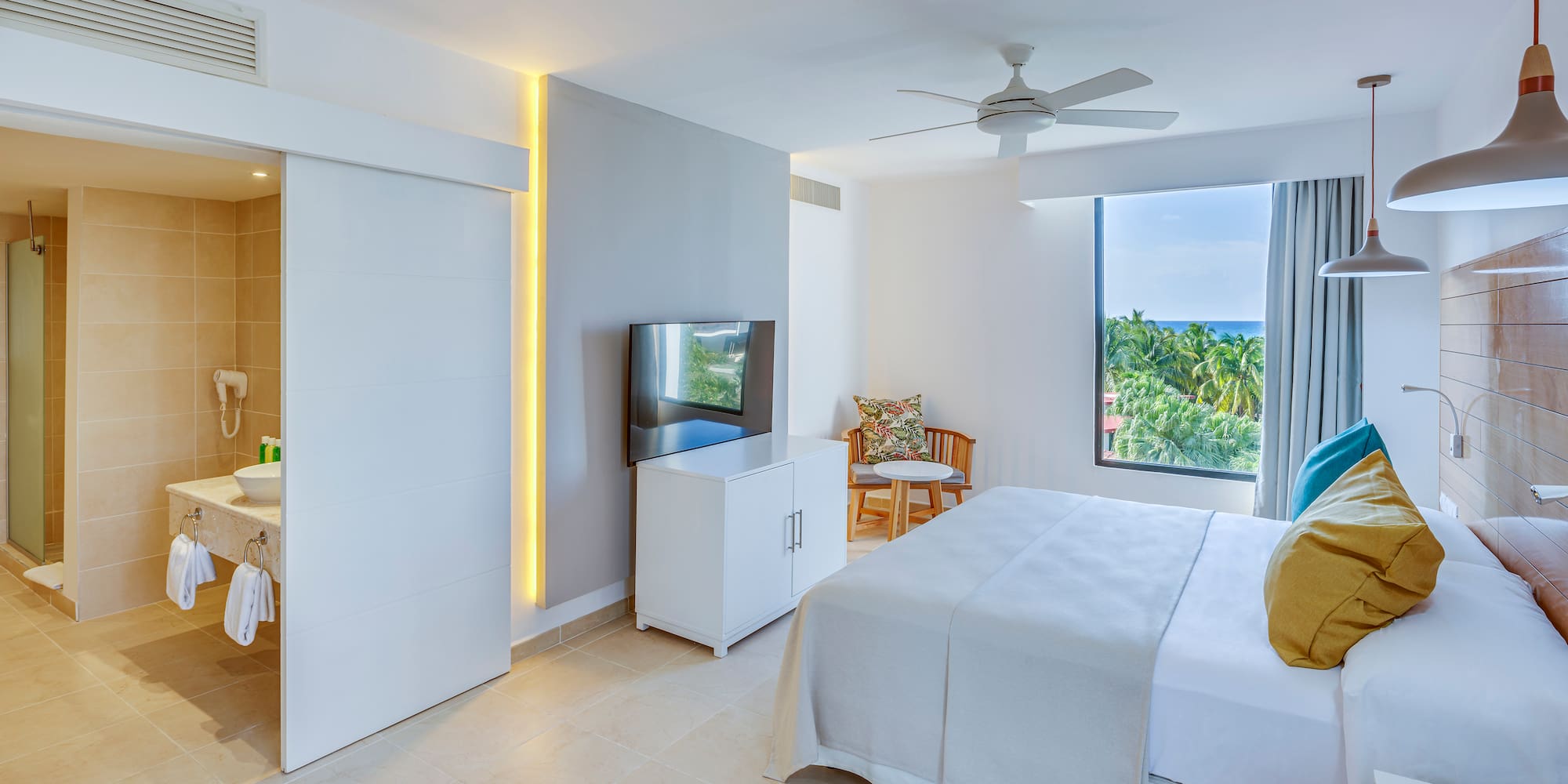 a bedroom with a bed and a television