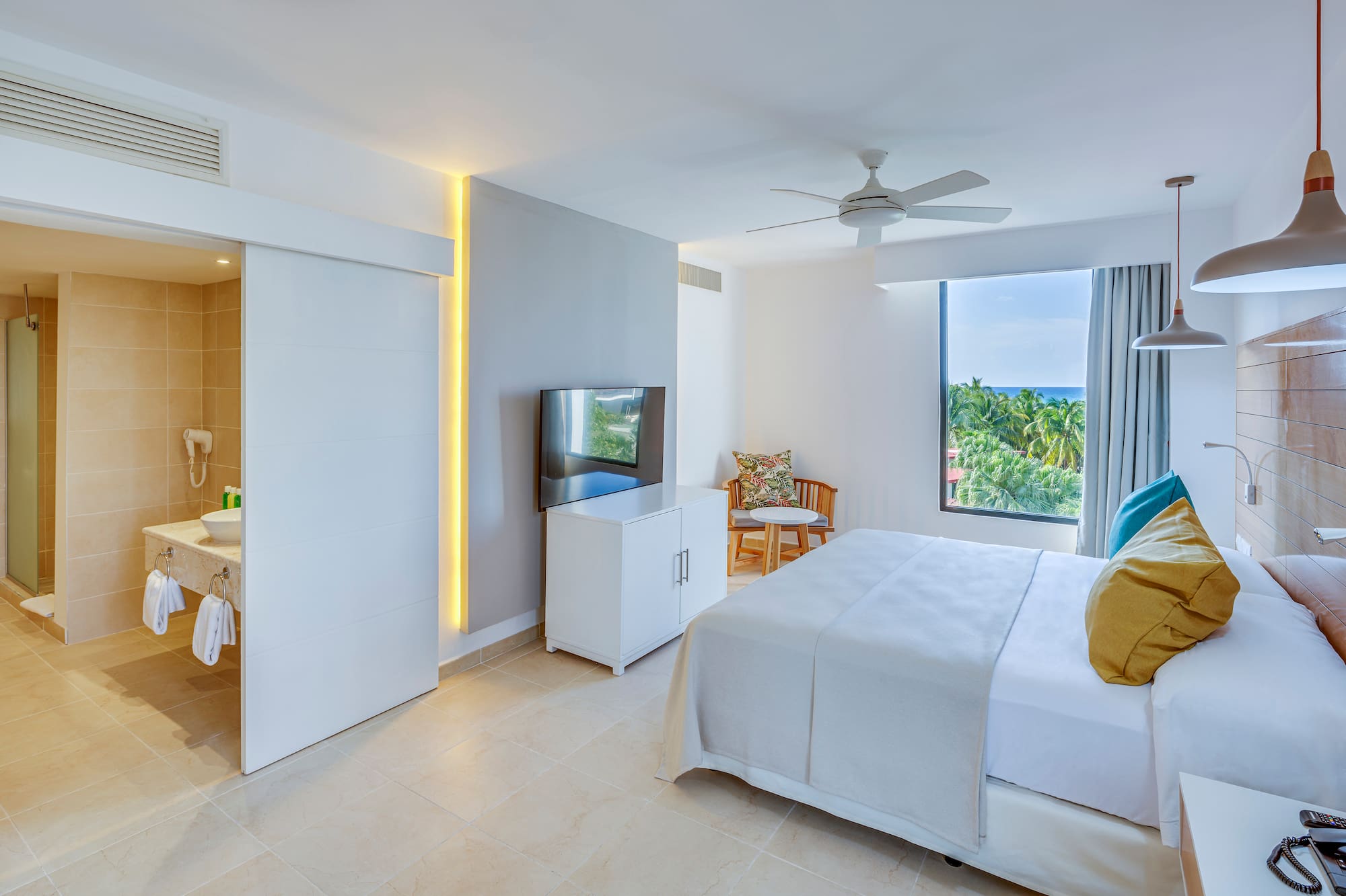 a bedroom with a bed and a television