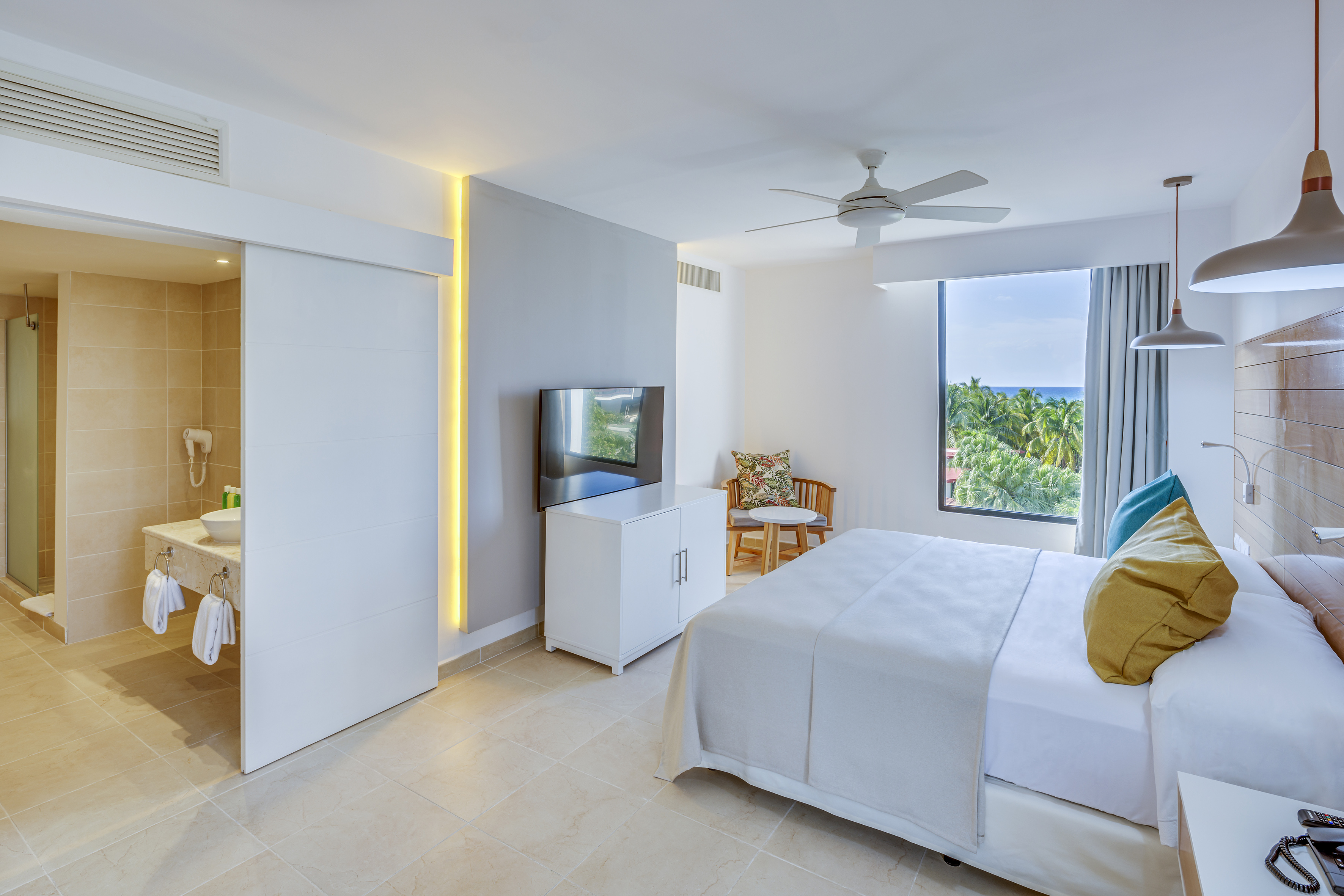 a bedroom with a bed and a television