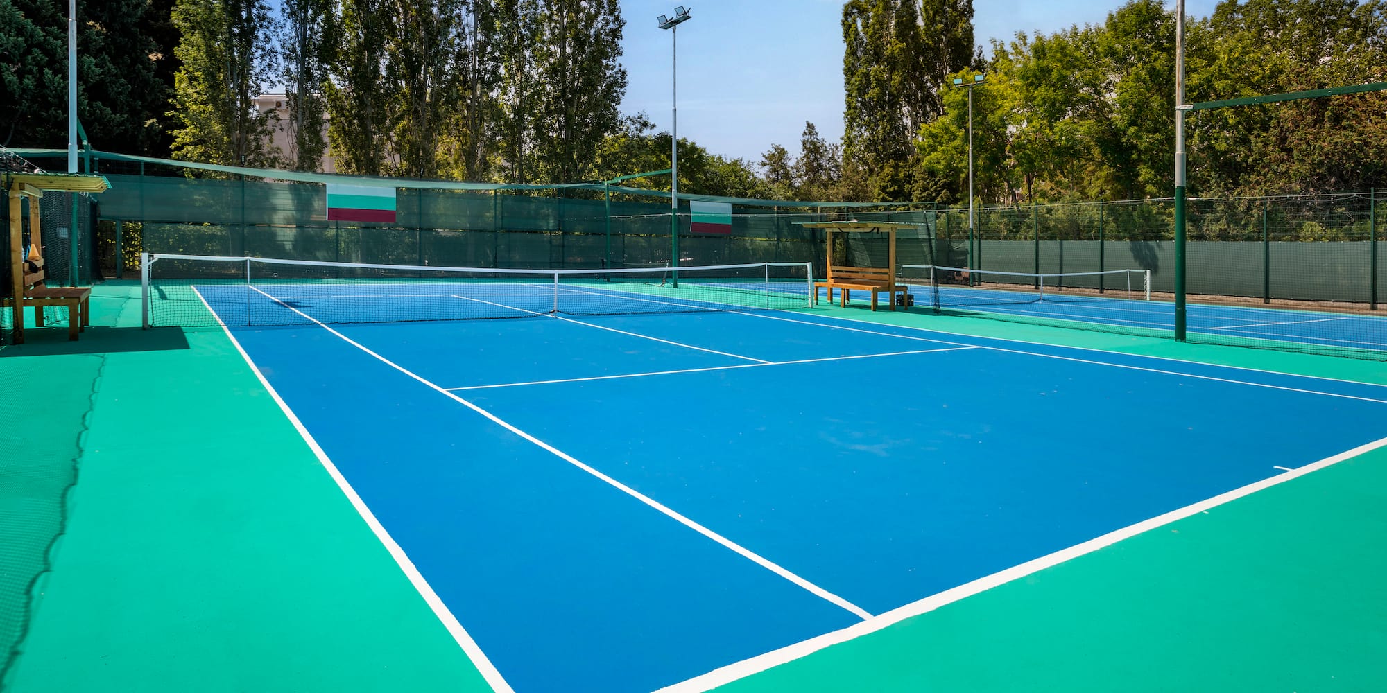 a tennis court with a bench and net