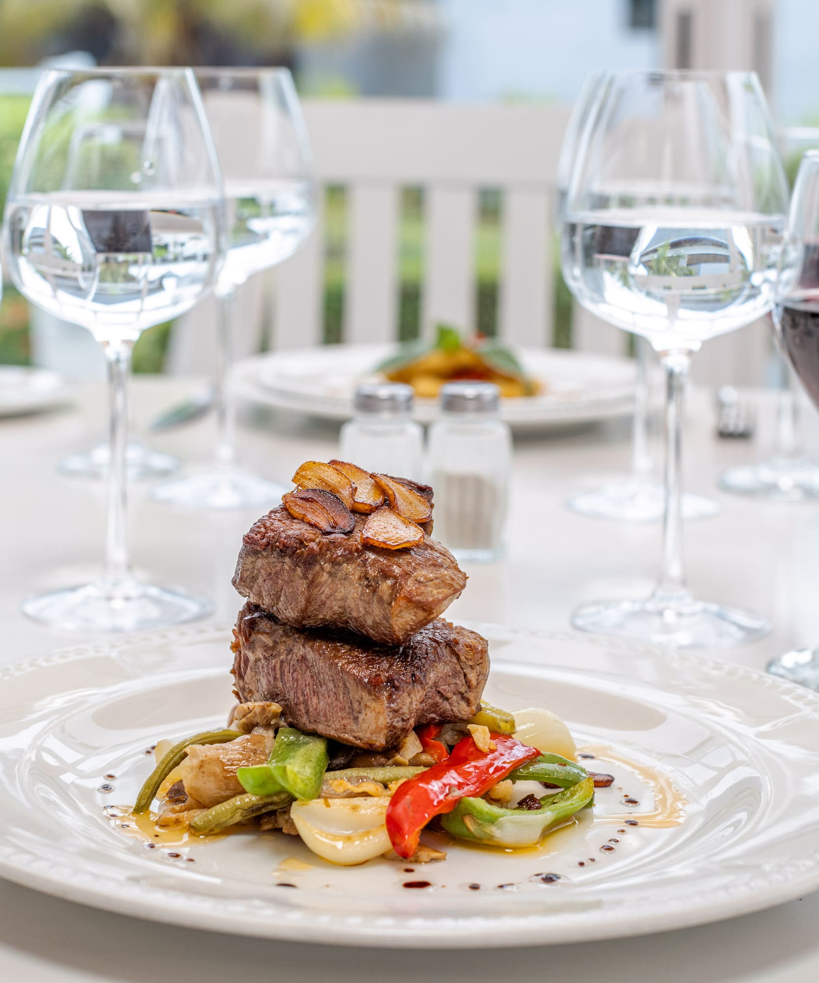 a plate of food and wine glasses