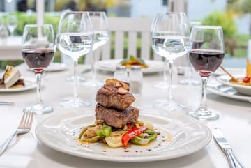 a plate of food and wine glasses