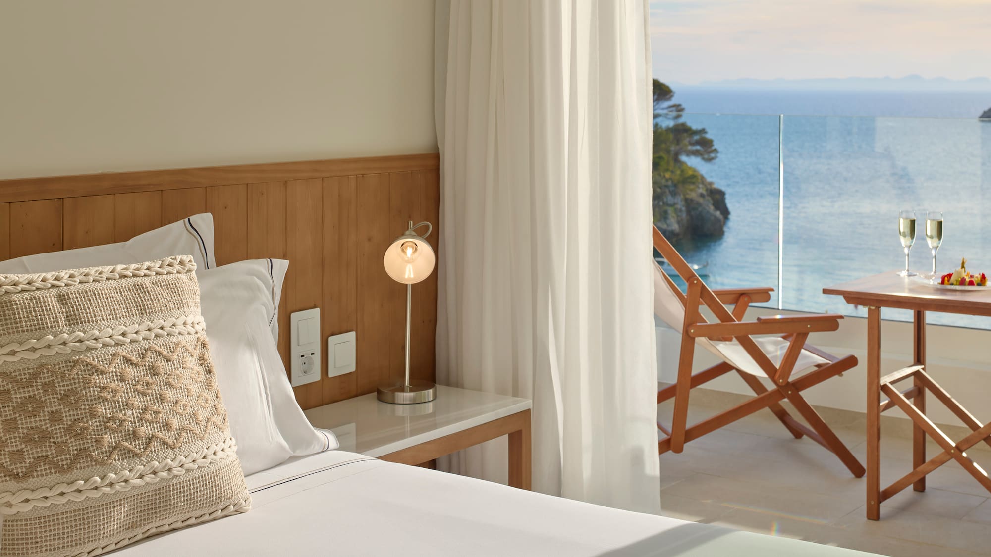 a bed with a table and a lamp next to a beach chair