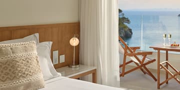 a bed with a table and a lamp next to a beach chair