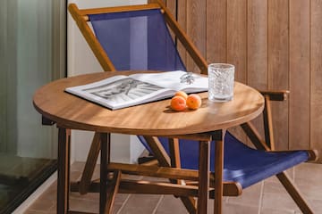 a chair and a table with a book and a lamp