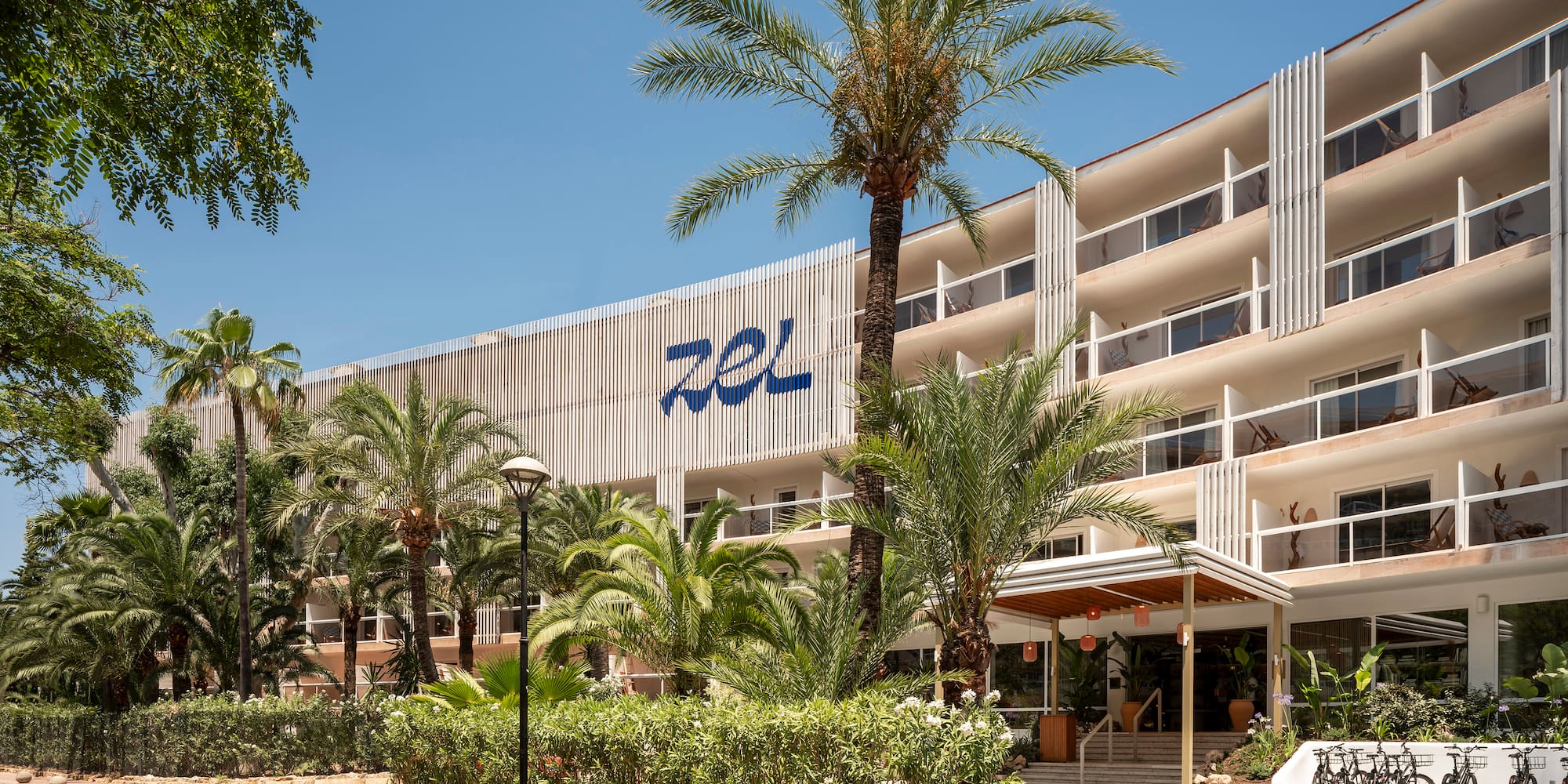 a building with palm trees and a road
