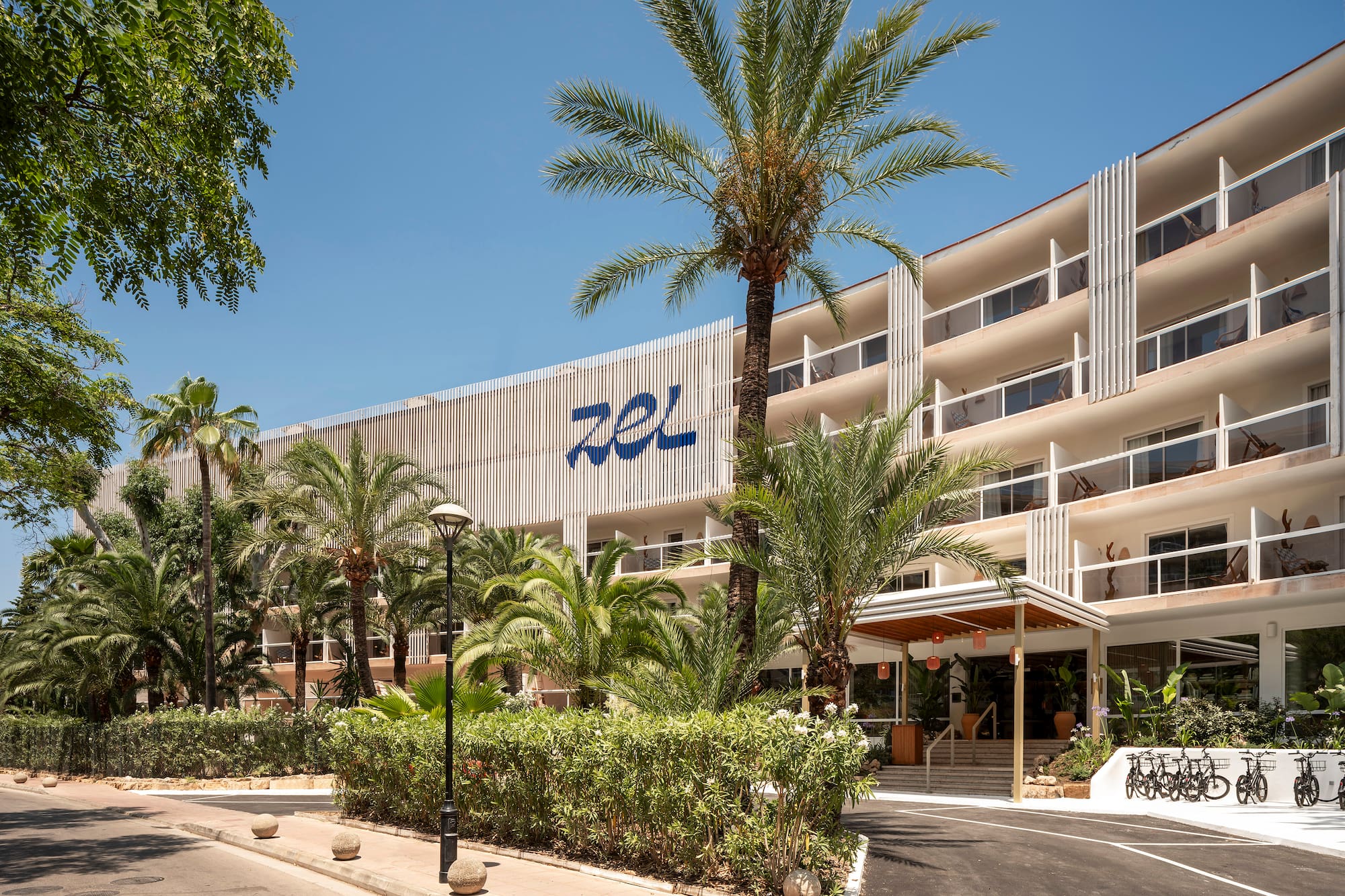 a building with palm trees and a road