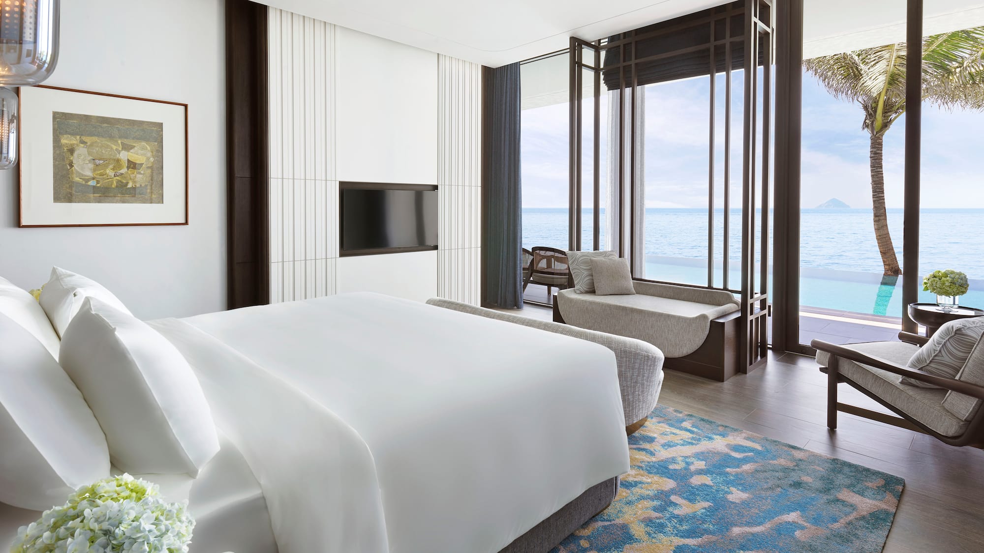 a room with a bed and a couch and a window