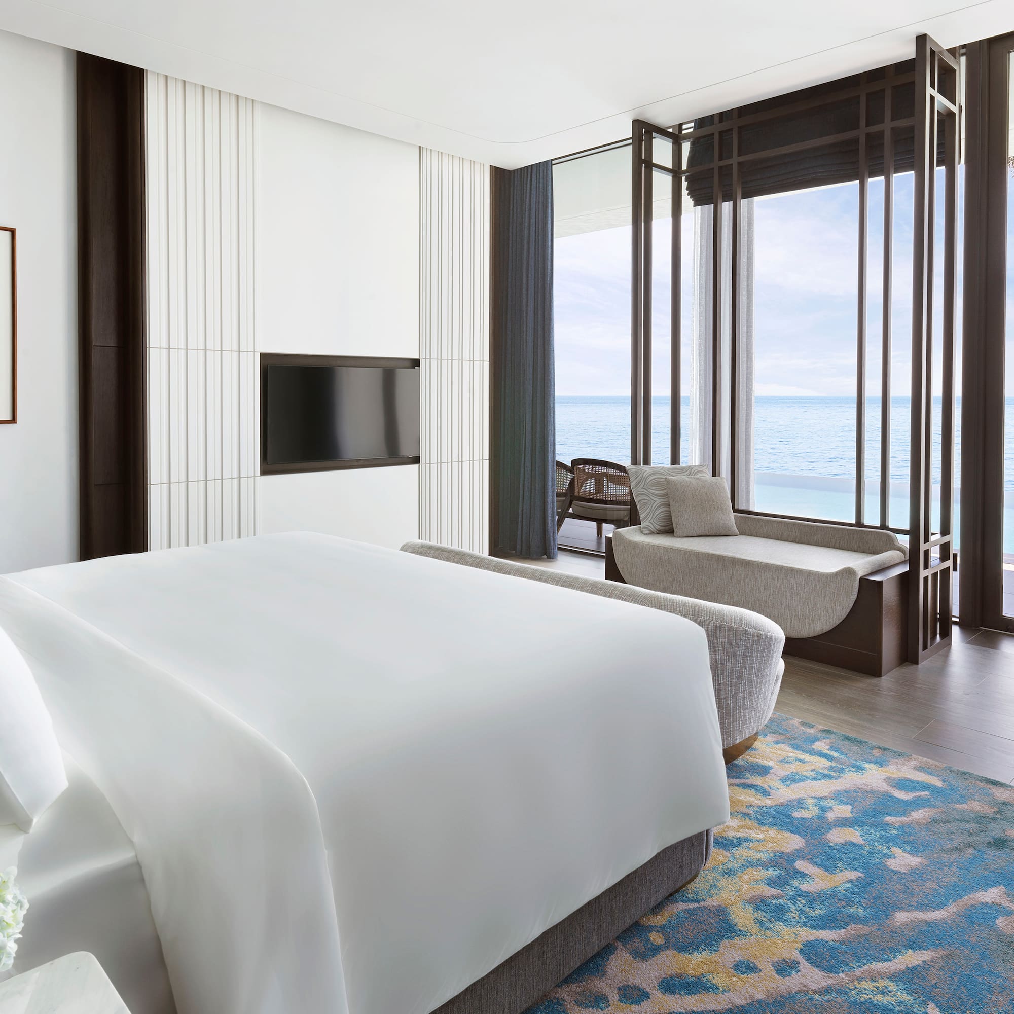 a room with a bed and a couch and a window