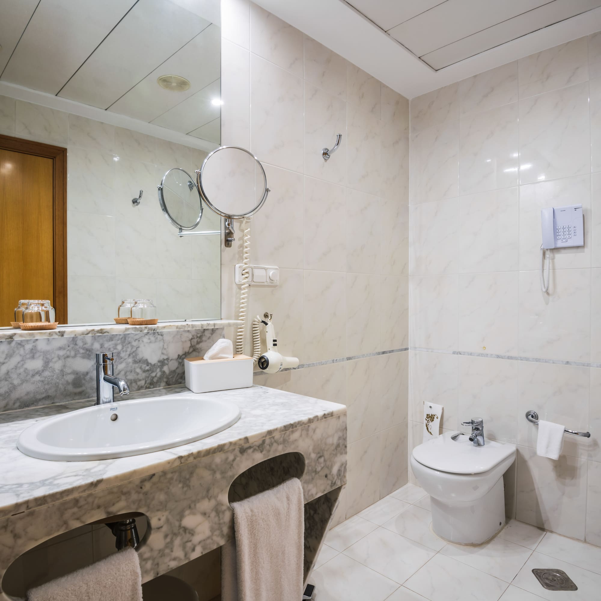 a bathroom with marble countertop and sink