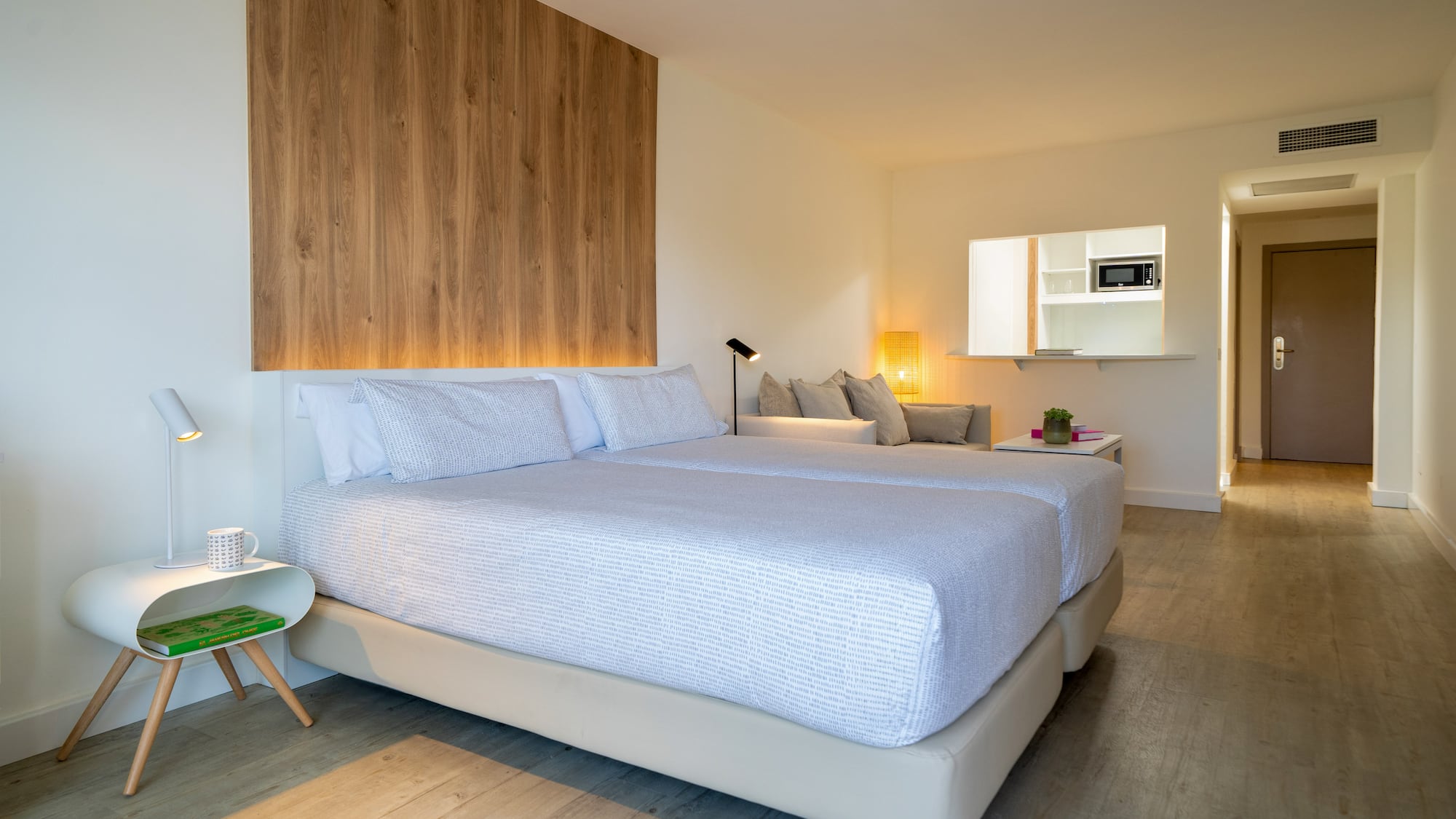 a room with two beds and a wood wall