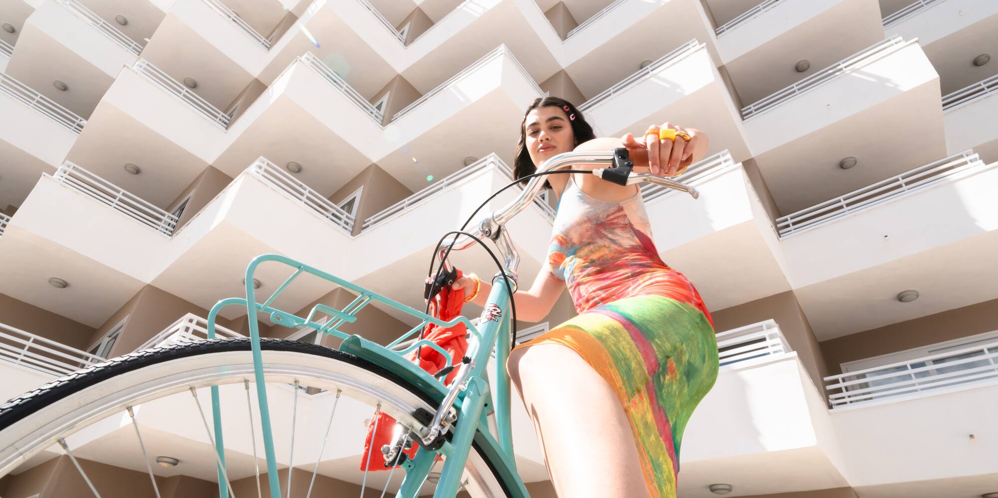 a woman on a bicycle in front of a building