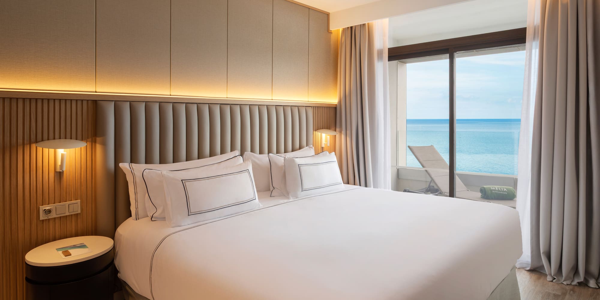 a bed with a view of the ocean