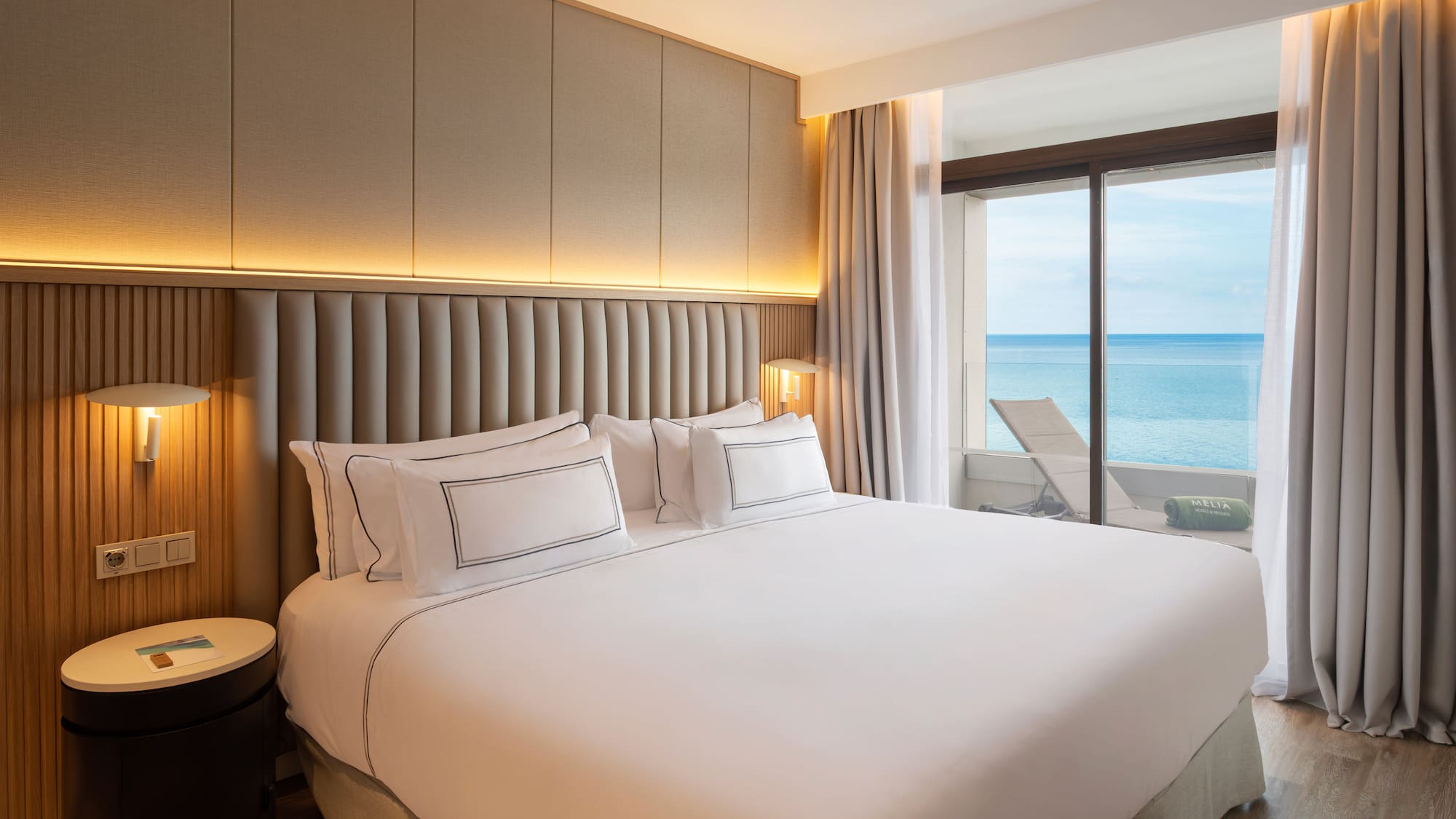 a bed with a view of the ocean