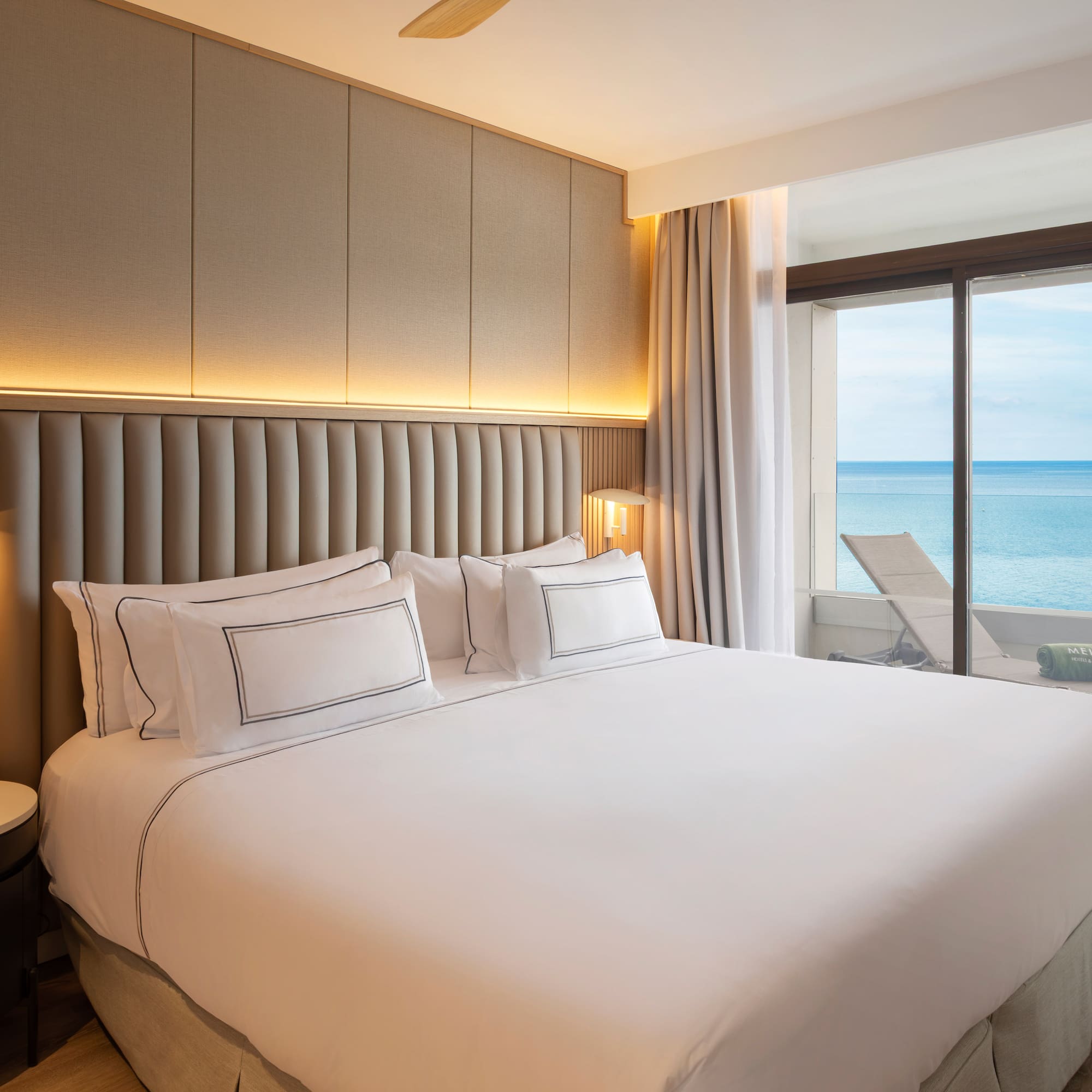 a bed with a view of the ocean