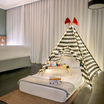 a bed with a tent and a tray of presents