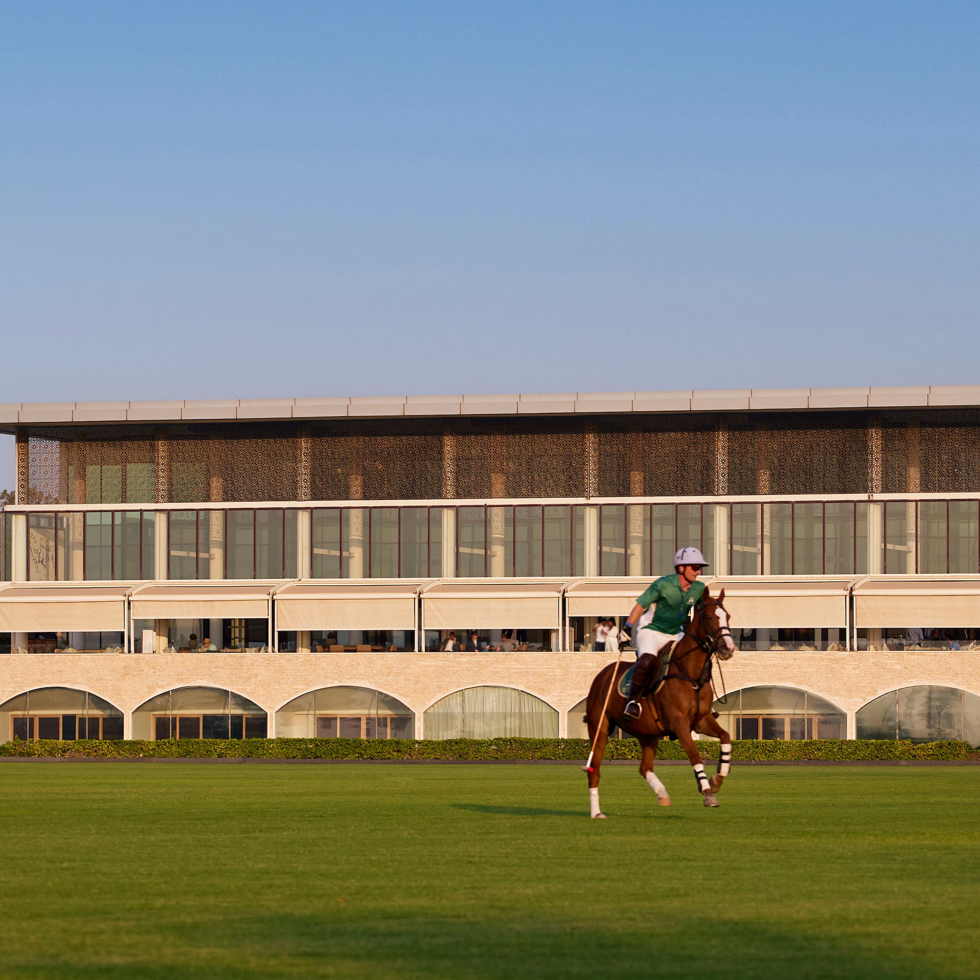 a man riding a horse on a grass field