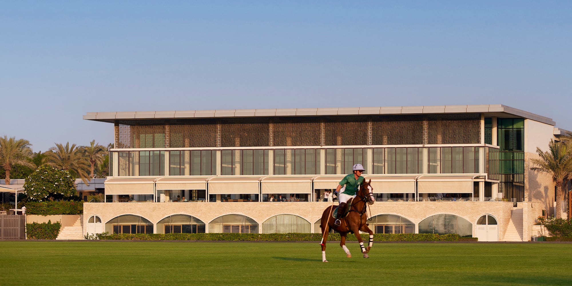 a man riding a horse on a grass field