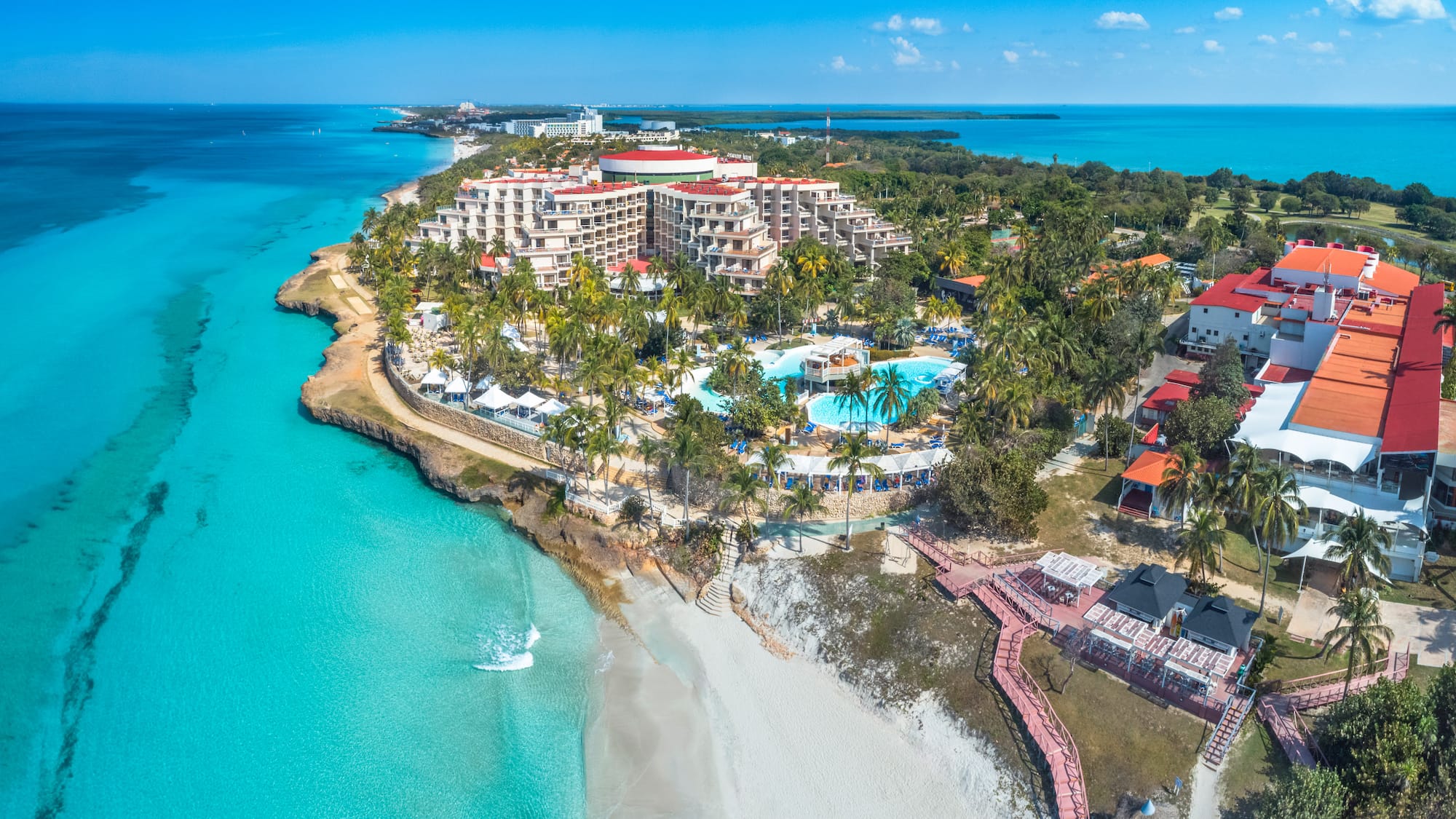 a resort with a pool and a beach