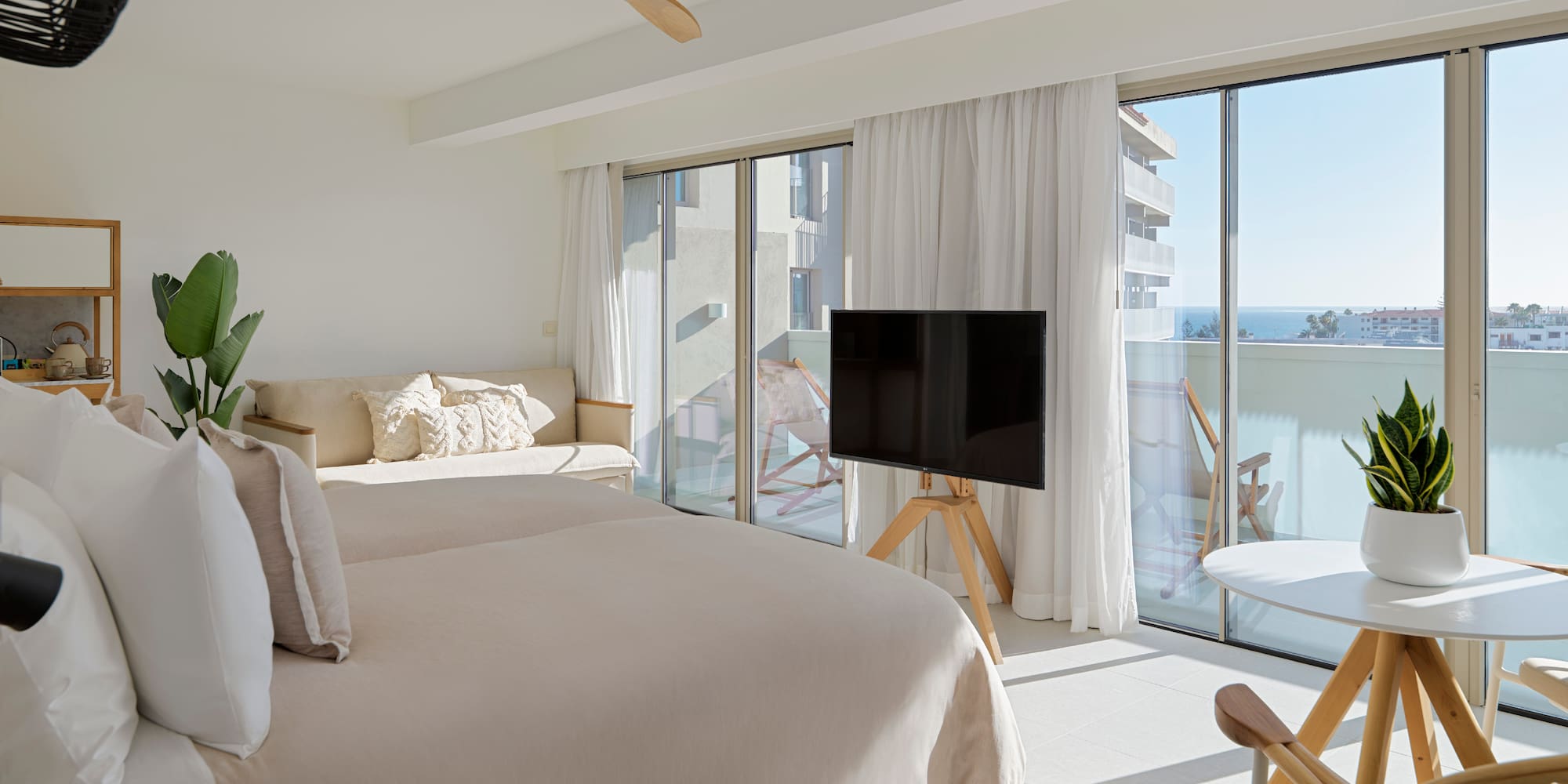 a bedroom with a television and a bed