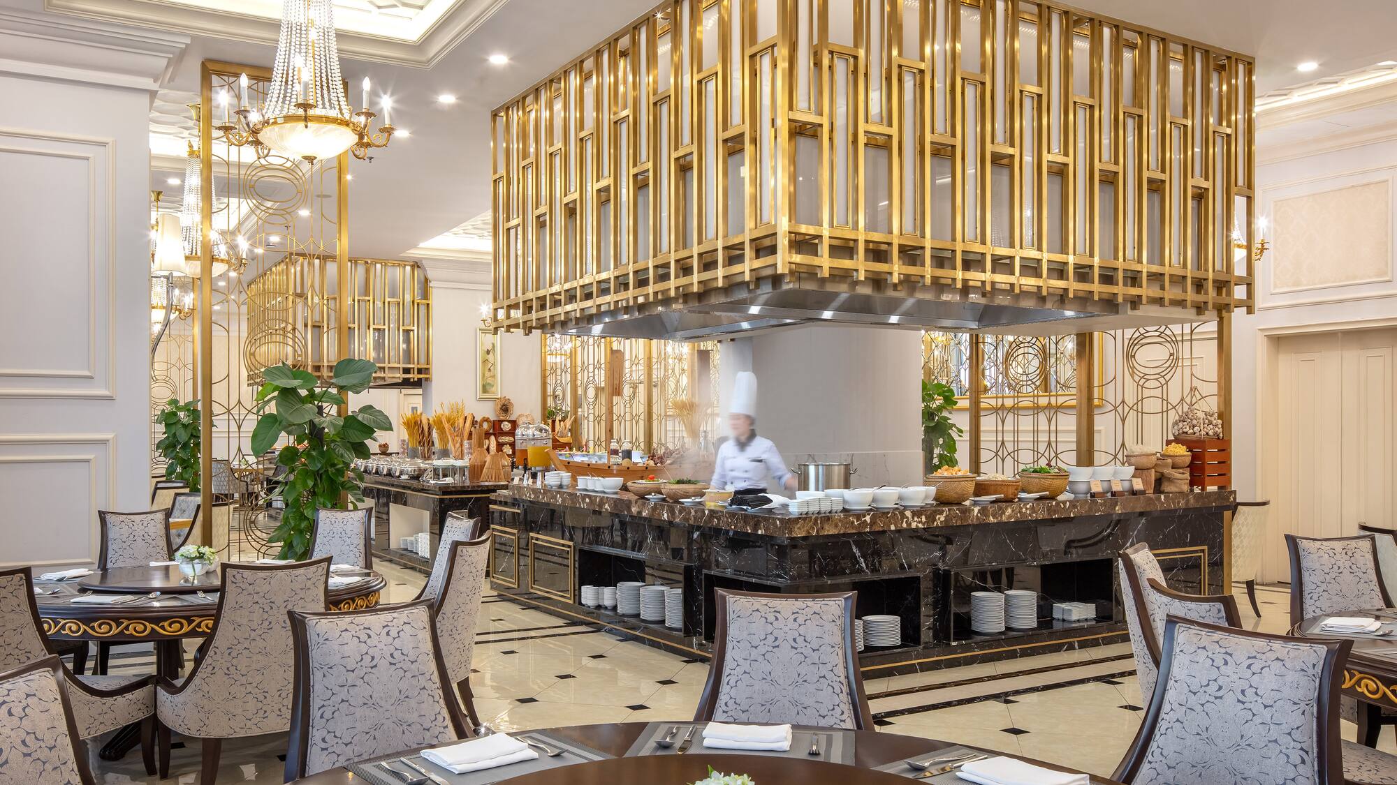 a restaurant with a chef behind the counter