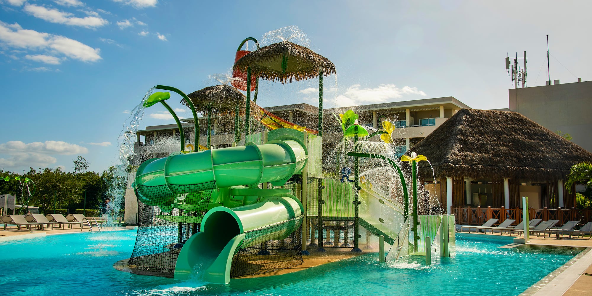 a water park with a slide and a pool