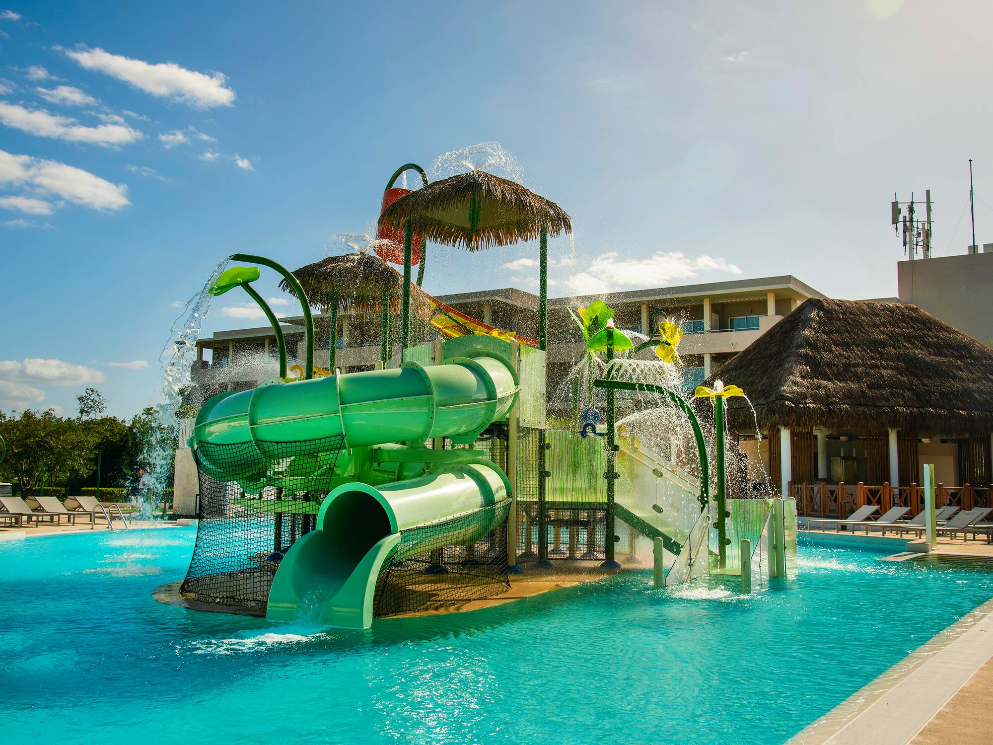 a water park with a slide and a pool