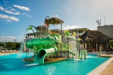 a water park with a slide and a pool