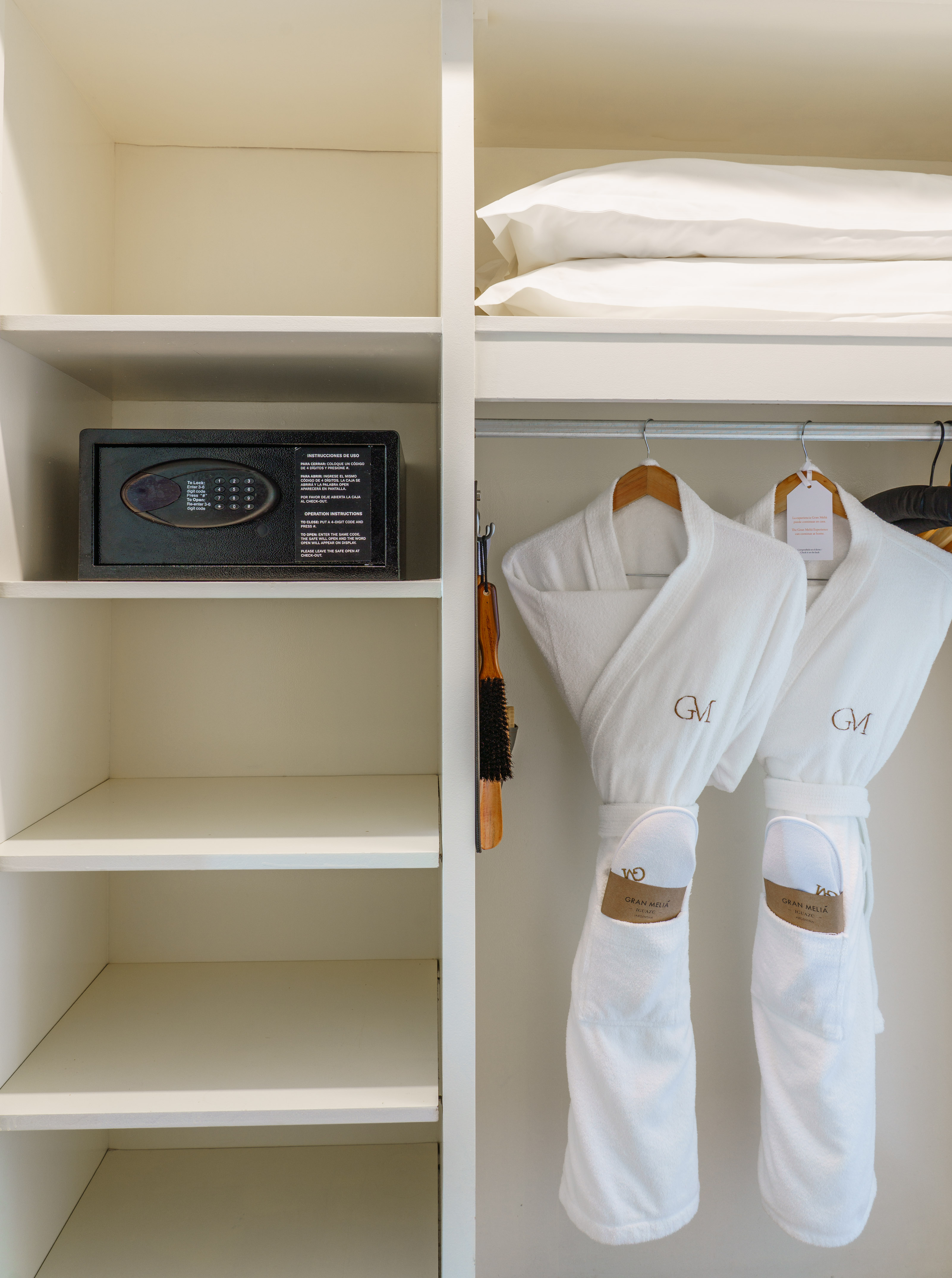 Hotel closet with security safe, Gran Melia bathrobes, slippers, and pillows.