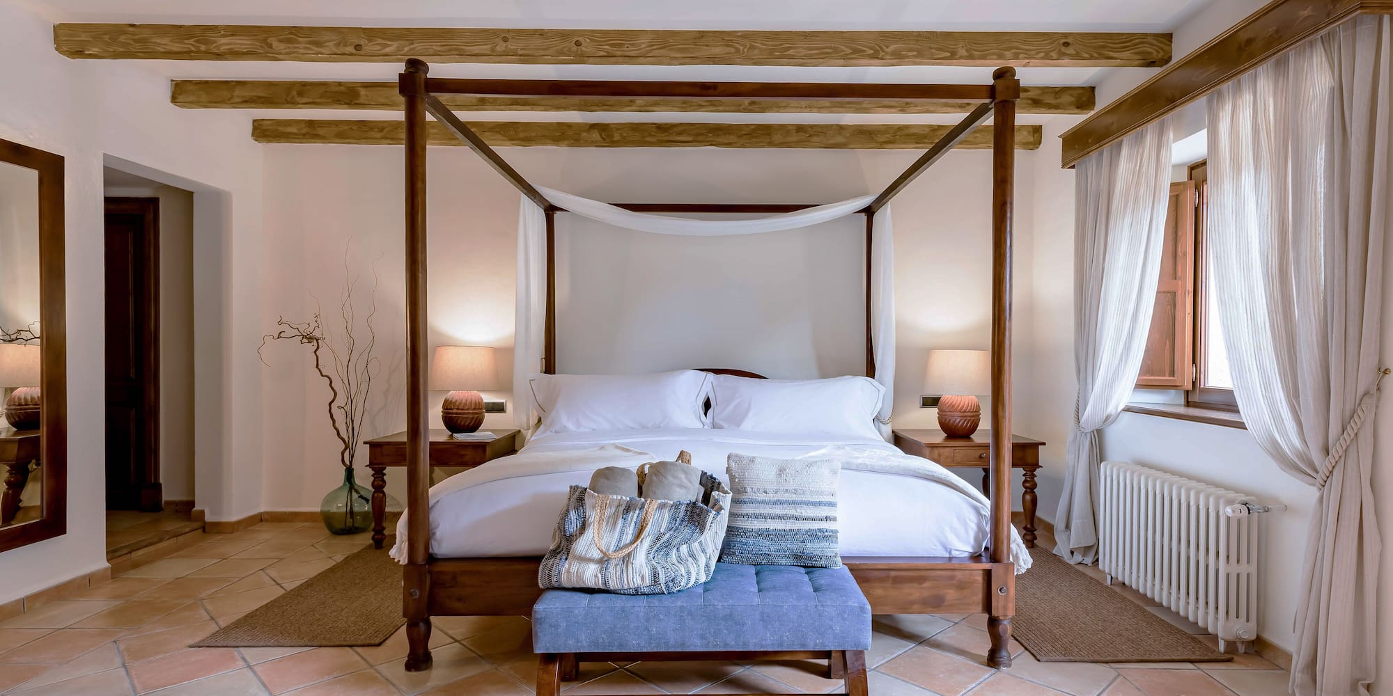 a bed with a canopy bed and a blue stool