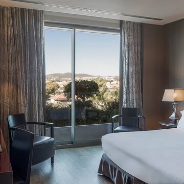 a bedroom with a bed and chairs and a table