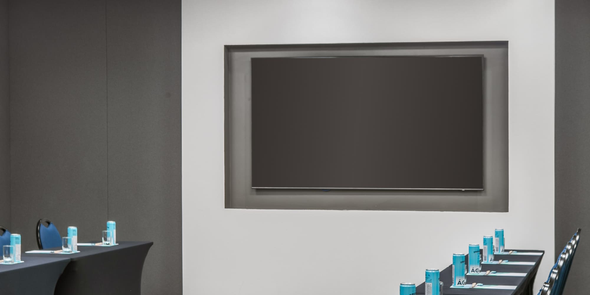 a room with long tables and chairs