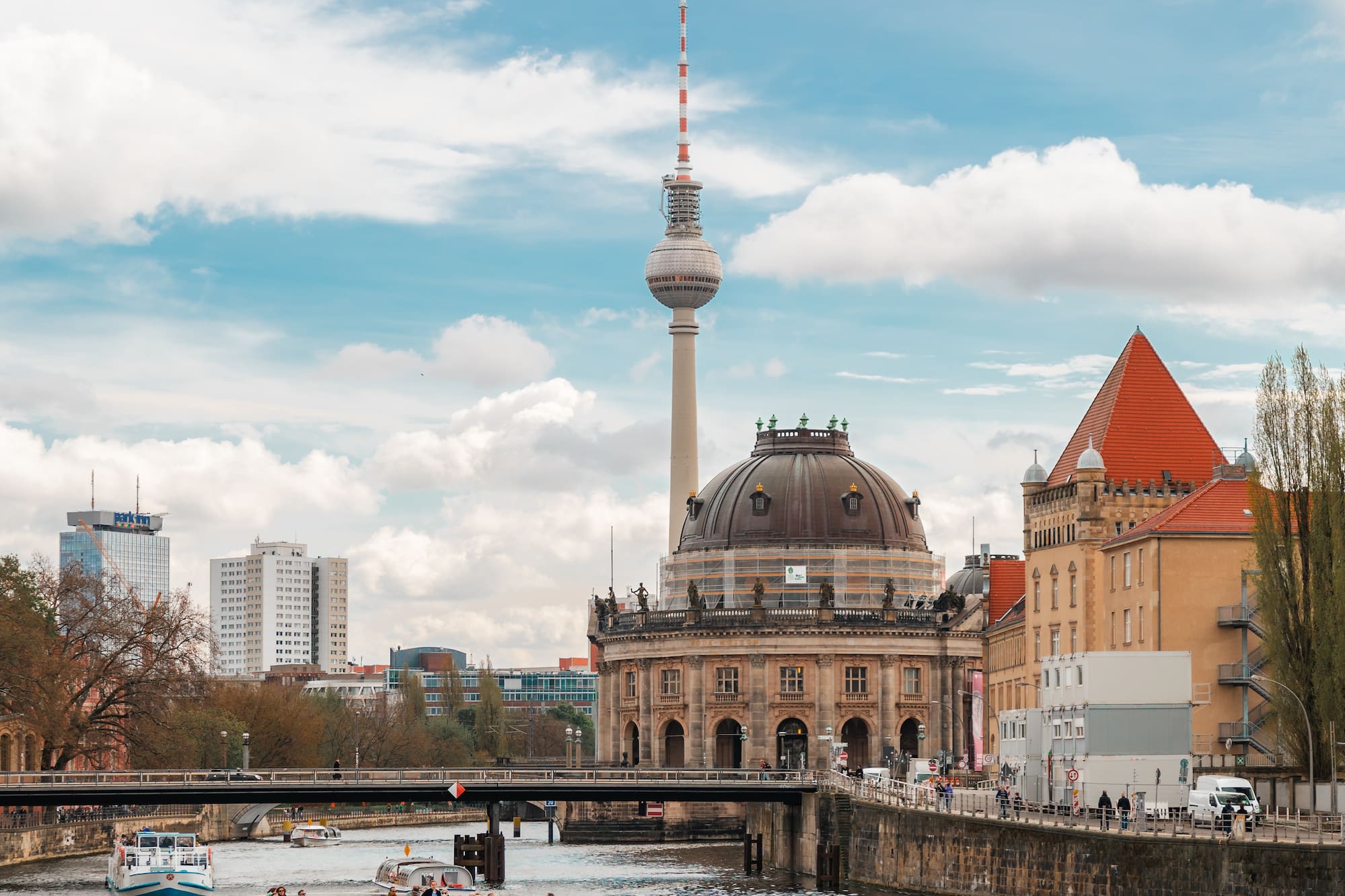 a boat on a river with a large tower in the background