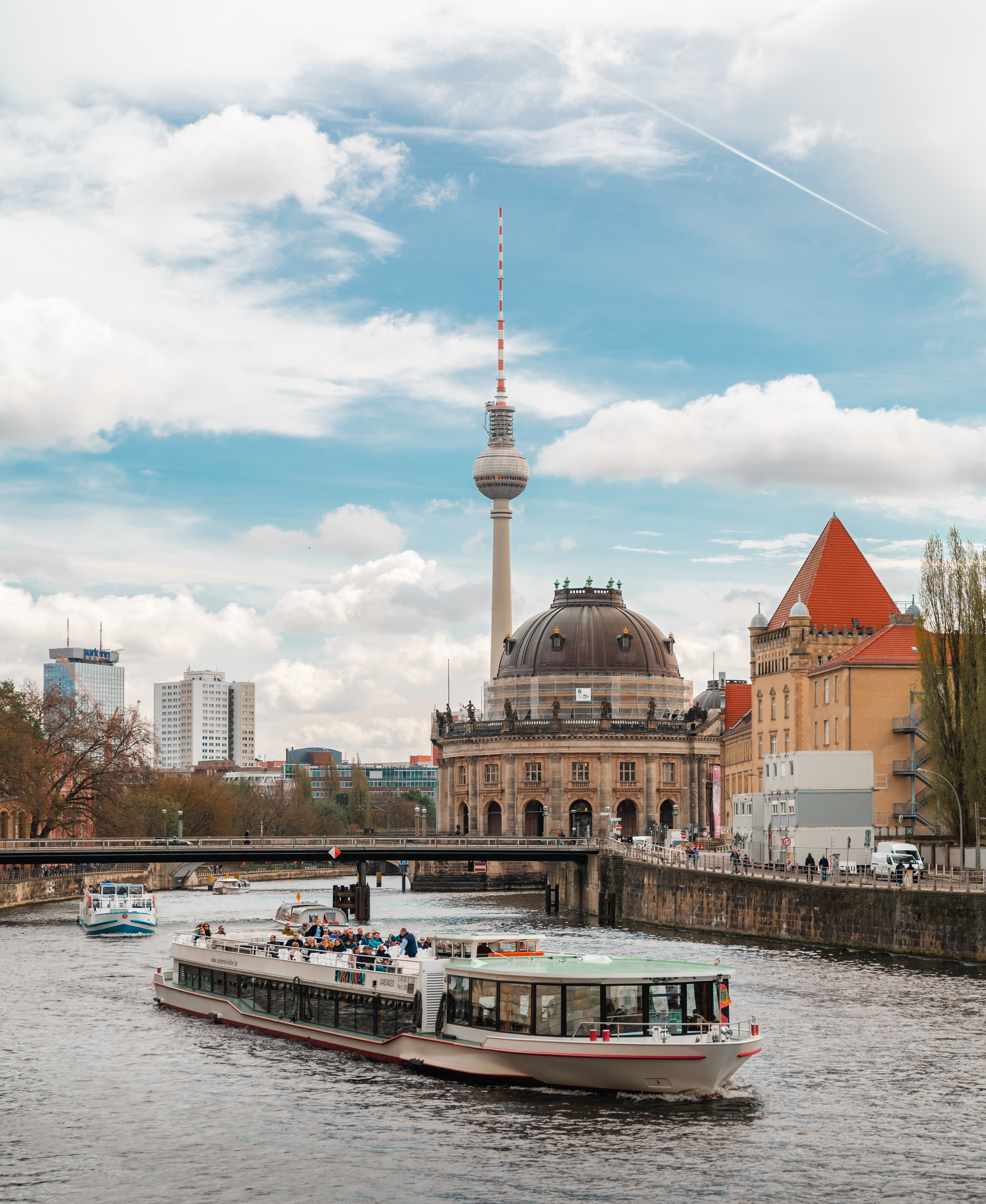 a boat on a river with a large tower in the background