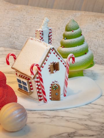 a gingerbread house and a christmas tree