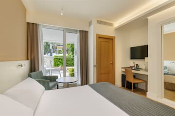 a room with a bed and a table and chairs