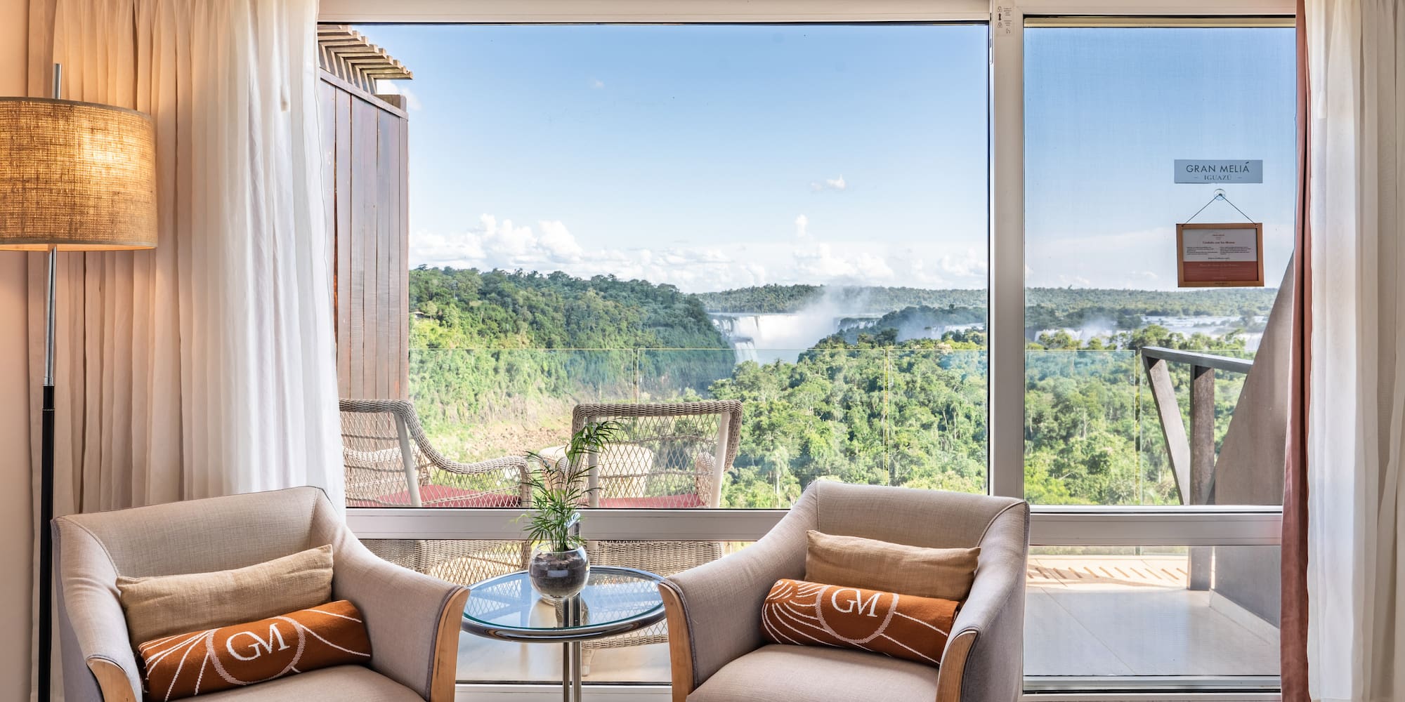 a room with a view of the mountains and trees