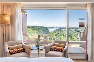 a room with a view of the mountains and trees