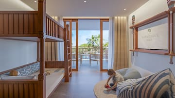 a boy playing in a room with bunk beds