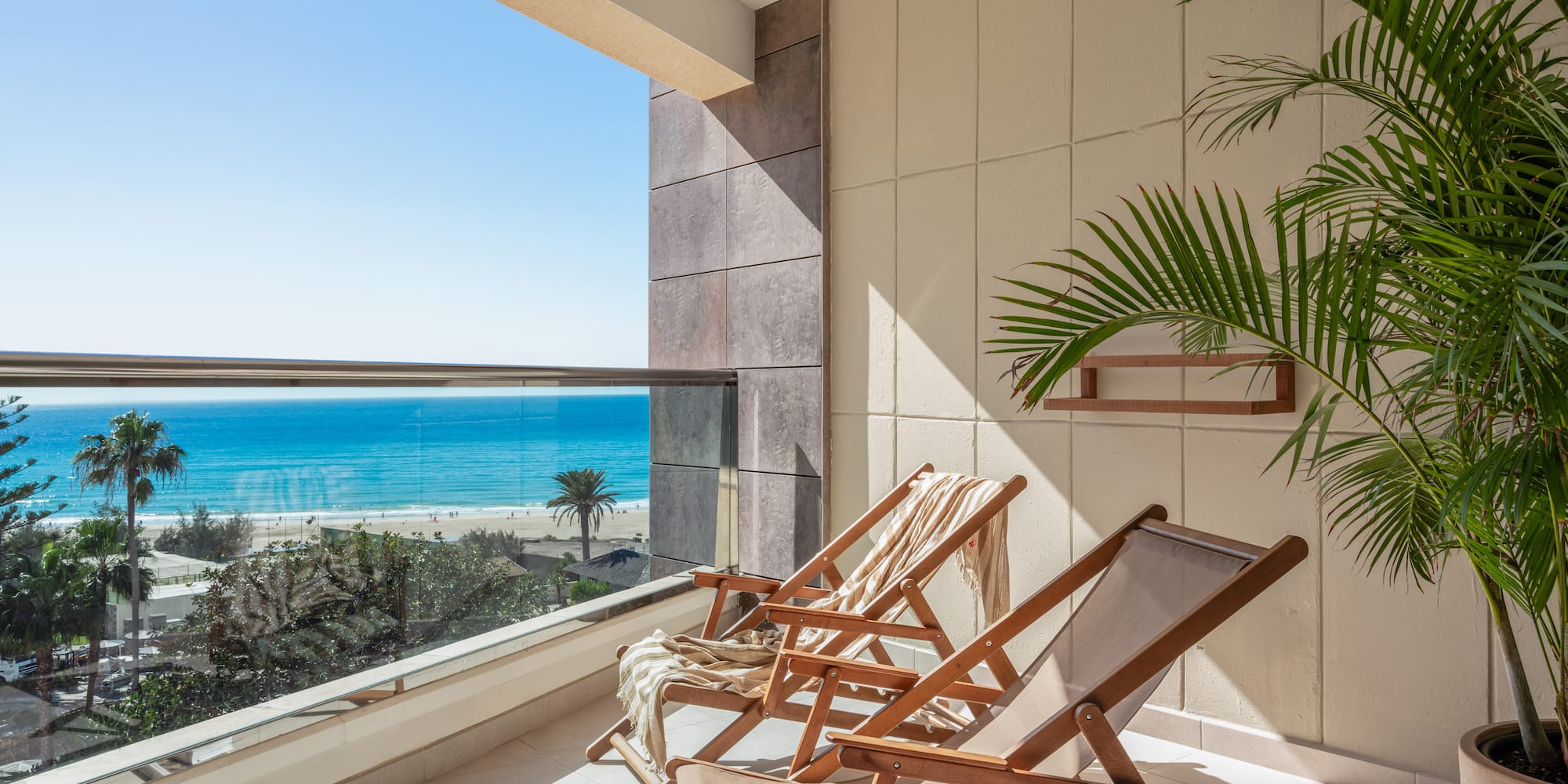 chairs on a balcony overlooking a beach