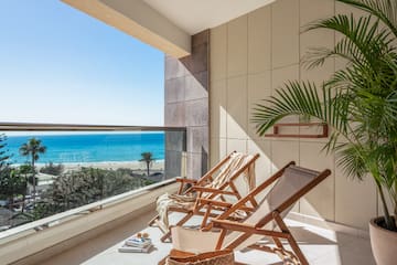 chairs on a balcony overlooking a beach