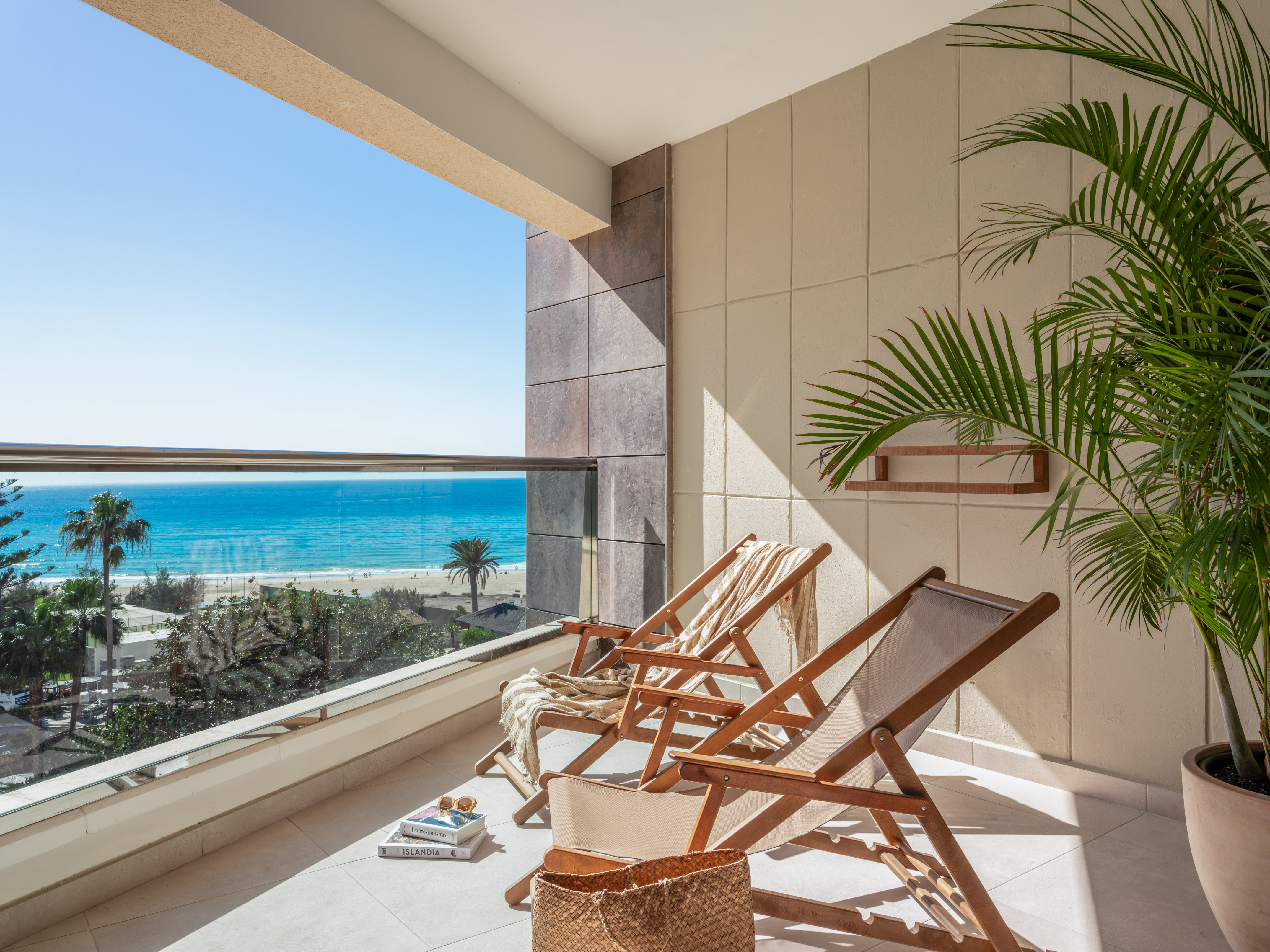 chairs on a balcony overlooking a beach