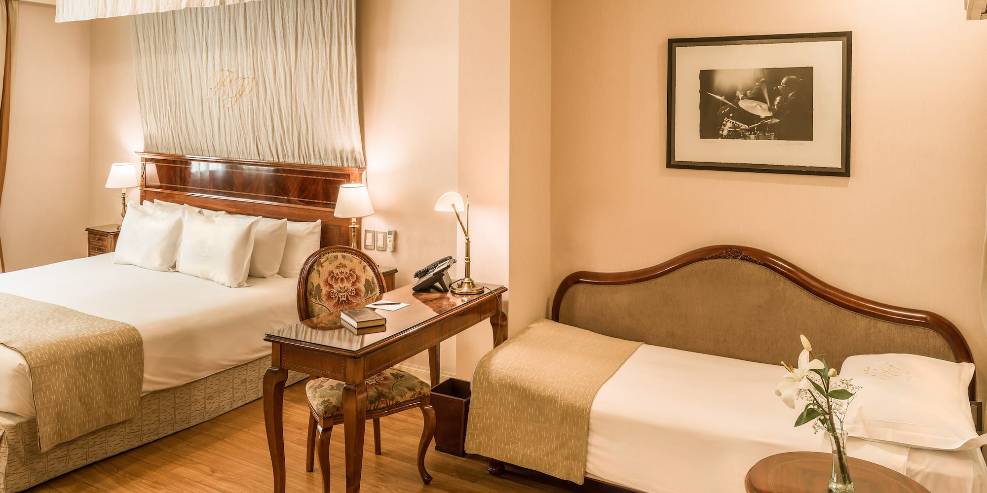 a room with two beds and a desk