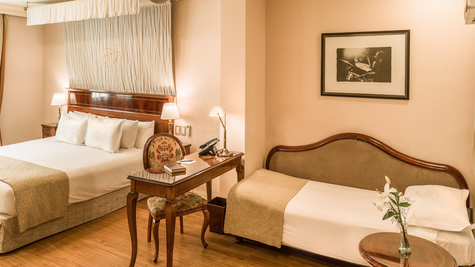 a room with two beds and a desk